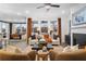 Cozy living room with fireplace, plush seating, and natural light, with view to dining room at 1603 Caldwell Bend Ln, Dacula, GA 30019