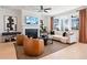 Stylish living room featuring a fireplace, modern decor, hardwood floors, and ample natural light, creating a warm atmosphere at 1603 Caldwell Bend Ln, Dacula, GA 30019