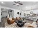Open-concept living area with modern kitchen, plush seating, and stylish decor with modern stairway at 1603 Caldwell Bend Ln, Dacula, GA 30019