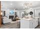 Bright, open living room featuring a fireplace, modern lighting, and seamless kitchen integration at 1603 Caldwell Bend Ln, Dacula, GA 30019