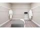 Spacious walk-in closet with ample shelving and a comfortable center ottoman at 1603 Caldwell Bend Ln, Dacula, GA 30019
