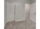 Spacious bedroom with gray carpeting and access to other rooms at 1699 Redan W, Lithonia, GA 30058