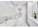 Elegant bathroom with marble floors, gold fixtures, and a soaking tub at 337 Pine Ne St # A, Atlanta, GA 30308