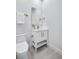 Modern bathroom with white vanity, gold fixtures, and gray tile flooring at 337 Pine Ne St # A, Atlanta, GA 30308