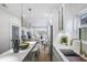 Bright, modern kitchen flows to dining and living area, featuring quartz countertops and stainless steel refrigerator at 337 Pine Ne St # A, Atlanta, GA 30308