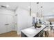 Open concept kitchen island with white quartz countertops and pendant lighting at 337 Pine Ne St # A, Atlanta, GA 30308