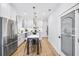 Bright, modern kitchen features white cabinets, stainless steel appliances, island with marble countertop, and a pantry at 337 Pine Ne St # A, Atlanta, GA 30308