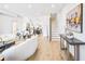 Open-concept living room leading to kitchen, featuring hardwood floors, modern furniture, and a staircase at 337 Pine Ne St # A, Atlanta, GA 30308