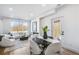 Bright living room flows to dining area, featuring a modern fireplace, large windows, and stylish white furniture at 337 Pine Ne St # A, Atlanta, GA 30308