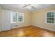 Bright bedroom with hardwood floors and two windows at 3496 Wesley Chapel Rd, Decatur, GA 30034