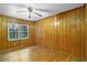 Simple bedroom with wood paneled walls and hardwood floors at 3496 Wesley Chapel Rd, Decatur, GA 30034