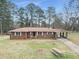 Brick ranch house with a spacious front yard at 3496 Wesley Chapel Rd, Decatur, GA 30034