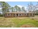 Brick ranch house with attached carport and picnic table in the yard at 3496 Wesley Chapel Rd, Decatur, GA 30034