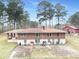 Back exterior of house showing large backyard and additional buildings at 3496 Wesley Chapel Rd, Decatur, GA 30034