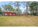 Ranch house with attached barn, surrounded by tall trees at 3496 Wesley Chapel Rd, Decatur, GA 30034