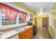 Kitchen with double sink, wood cabinets and vinyl flooring at 3496 Wesley Chapel Rd, Decatur, GA 30034