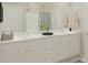 Double vanity bathroom with white cabinets and neutral decor at 512 Altamaha Ct, Locust Grove, GA 30248