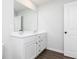 Bathroom featuring a double vanity with a large mirror and modern fixtures, and a white door at 512 Altamaha Ct, Locust Grove, GA 30248