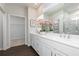 Bright bathroom featuring a double vanity with white cabinets and a glass-enclosed shower at 512 Altamaha Ct, Locust Grove, GA 30248