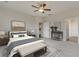 Spacious bedroom featuring a comfortable bed, ceiling fan, and neutral decor at 512 Altamaha Ct, Locust Grove, GA 30248