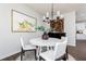 Bright dining area with white table set, chandelier, and decorative wall art at 512 Altamaha Ct, Locust Grove, GA 30248