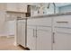 Close up on a stainless steel dishwasher, white cabinets, and granite countertops in a modern kitchen at 512 Altamaha Ct, Locust Grove, GA 30248