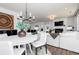 Cozy living room showcases a modern chandelier, fireplace, and comfortable seating arrangement at 512 Altamaha Ct, Locust Grove, GA 30248