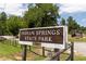 Entrance sign to Indian Springs State Park with a rustic wooden fence and natural rock formations at 512 Altamaha Ct, Locust Grove, GA 30248