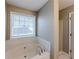 Bathroom with jetted tub and shower at 1708 Queen Victoria Ct, Locust Grove, GA 30248