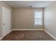 Bright bedroom featuring a window and neutral wall colors at 1708 Queen Victoria Ct, Locust Grove, GA 30248