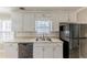 Kitchen with white cabinets, double sink and appliances at 1708 Queen Victoria Ct, Locust Grove, GA 30248