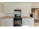Kitchen with white cabinets and black appliances at 1708 Queen Victoria Ct, Locust Grove, GA 30248