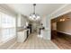 Eat-in kitchen with white cabinets and view to living room at 1708 Queen Victoria Ct, Locust Grove, GA 30248