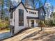 Stylish two-story house featuring white brick, dark accents, and a metal roof at 3491 Sexton Woods Dr, Atlanta, GA 30341