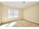 Bright bedroom with window, neutral walls, and carpeted floor at 980 Windsor Place Cir, Grayson, GA 30017