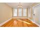 Spacious dining room with hardwood floors and three windows at 980 Windsor Place Cir, Grayson, GA 30017