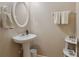 Clean and updated bathroom with pedestal sink and white fixtures at 2128 Mill Garden Run, Buford, GA 30519