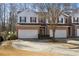 Two-story brick townhouse with a 2-car garage and nicely landscaped yard at 2128 Mill Garden Run, Buford, GA 30519