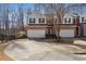 Brick front townhouse with 2-car garage, and manicured landscaping at 2128 Mill Garden Run, Buford, GA 30519