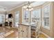 Kitchen with breakfast bar, white cabinets, and view of living room at 2128 Mill Garden Run, Buford, GA 30519