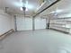 Spacious two-car garage with painted floor and shelving at 4550 Cypress Ridge Ct, Stone Mountain, GA 30083