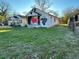 White bungalow with overgrown vines and graffiti, needing renovation at 654 English Nw Ave, Atlanta, GA 30318