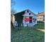 White bungalow with overgrown vines and graffiti, needing renovation at 654 English Nw Ave, Atlanta, GA 30318