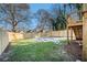 Fenced backyard with grassy area, partially covered in winter snow at 862 Hobson Sw St, Atlanta, GA 30310