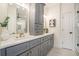 Modern bathroom with gray cabinets, quartz countertops, and a walk-in shower at 862 Hobson Sw St, Atlanta, GA 30310