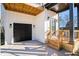 Modern farmhouse with black garage door and wooden porch at 862 Hobson Sw St, Atlanta, GA 30310