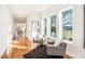 Light-filled hallway with hardwood floors and seating area at 862 Hobson Sw St, Atlanta, GA 30310