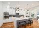 Modern kitchen with white cabinets, marble countertops, and high-end appliances at 862 Hobson Sw St, Atlanta, GA 30310