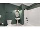 Bathroom with subway tile, pedestal sink, and bathtub at 1648 Beacon Hill Ne Blvd, Atlanta, GA 30329