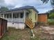 Green house with wrap-around porch and detached structure under construction at 1777 Yellow Nw St, Conyers, GA 30012